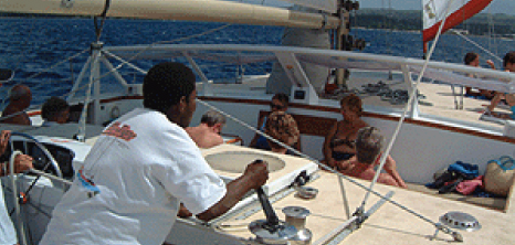Guests Onboard El Tigre Sailing Cruises Relaxing While Listening to a Crew Member, Barbados Pocket Guide