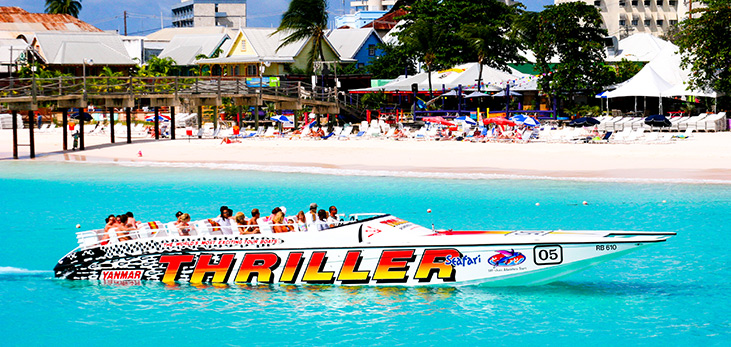 Excited Visitors on Board Thriller's Specially Designed 55' Off-Shore Power Boat, Wave Their Hands in Excitement as They Head Out to a Sea Turtle & Shipwreck Snorkel, Barbados Pocket Guide