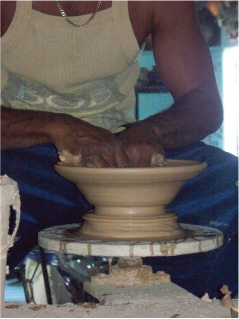 Potter at Work with Clay on a Potters Wheel, Chalky Mount Potteries, Chalky Mount, St. Andrew, Barbados Pocket Guide