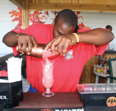 A Barman Mixing a Fruit Punch at Copacabana Beach Bar & Grill, Barbados Pocket Guide