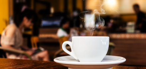 Hot Cup of Coffee on a Table at the Coffee Shop