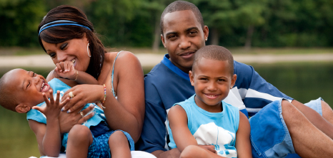 Couple Relaxing with Two Sons on the Lawn