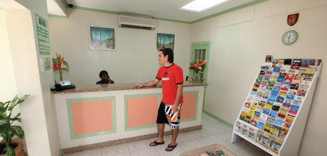 Visitor Waiting for Information at Worthing Court's Reception Desk, Barbados Pocket Guide