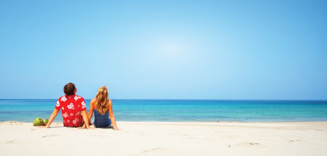 Couple Sitting on the Beach & Looking Out to the Ocean, Barbados Pocket Guide